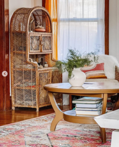A room with a rug and a wood table