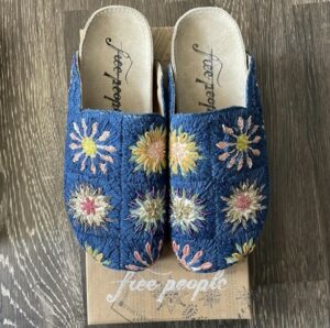 Blue embroidered Free People mules with pink and white flowers