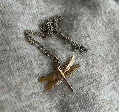 A dragon fly gold necklace
