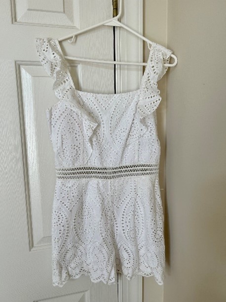 A white top on a white hanger. 