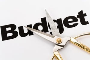A pair of scissors above the word 'Budget'
