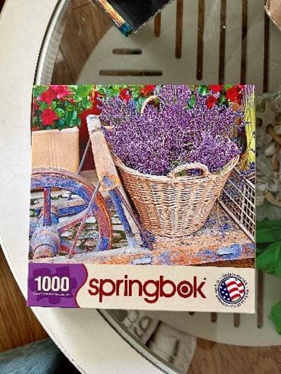 Springbok 1000-piece puzzle box featuring a wicker basket of lavender flowers.