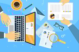 Collaborative data analysis scene with a laptop, charts on papers, glasses, a magnifying glass, and multiple hands organizing information.