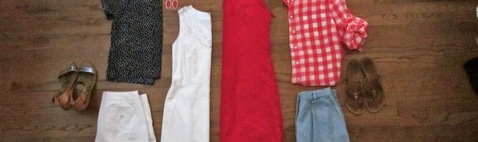 Flat lay of women's outfits on a wooden floor: red dress, red plaid shirt, blue jeans, white garments, and brown sandals.