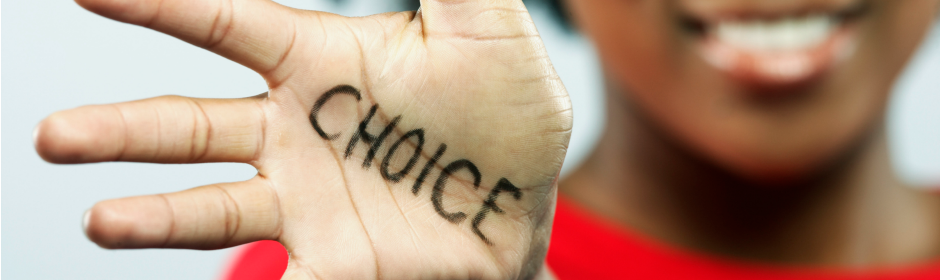 Palm with the word CHOICE written on it, smiling person in the blurred background.