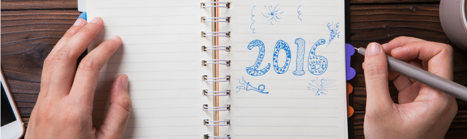 Two hands rest on a spiral notebook open to a page with blue 2016 doodles and a marker.