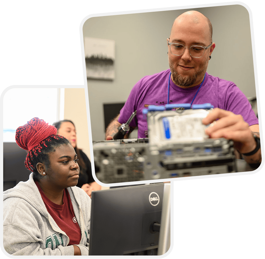 Two people in a computer lab: a man in a purple shirt assembles hardware while a woman with red braids uses a Dell monitor.