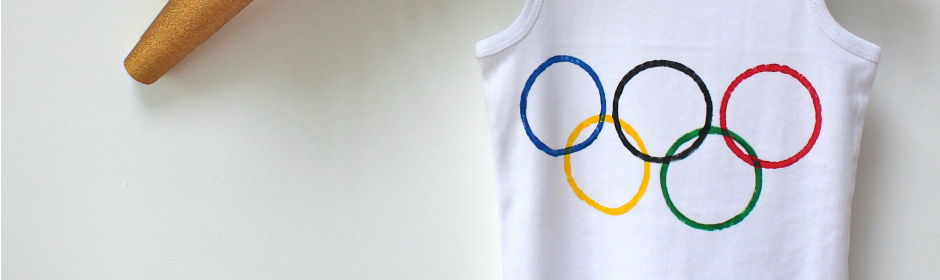 White tank top with Olympic rings logo hanging on a white wall