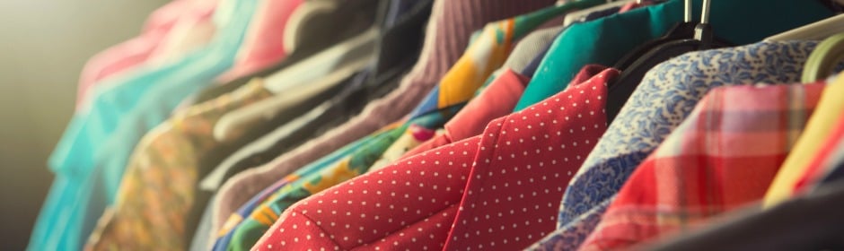 Colorful shirts on a clothing rack in a closet