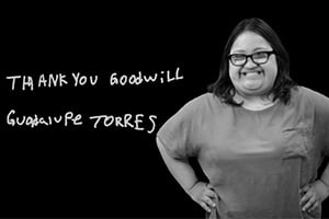 Smiling woman stands with hands on hips beside handwritten 'THANK YOU GOODWILL' text on a black background.
