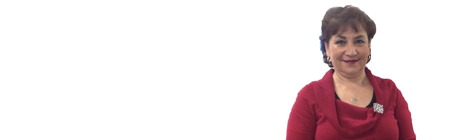 Smiling woman in a red sweater against a white background.