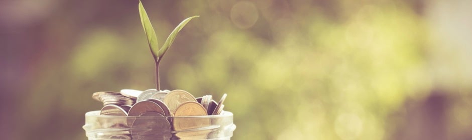Jar of coins with a small plant sprouting from the center, symbolizing financial growth.