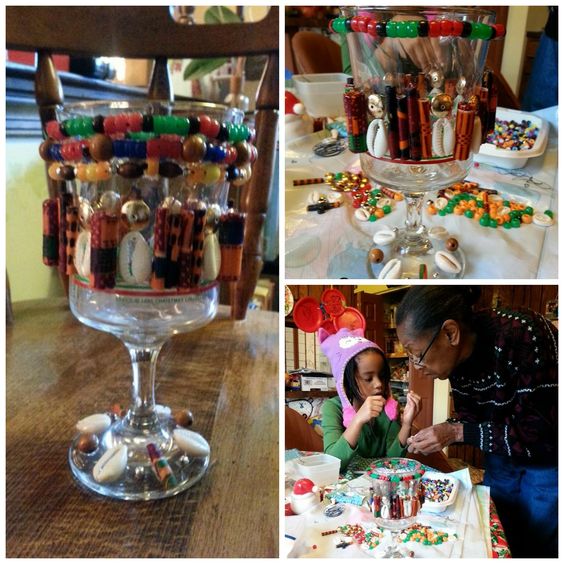 Glass goblets wrapped with colorful bead garlands and shells for a craft project.