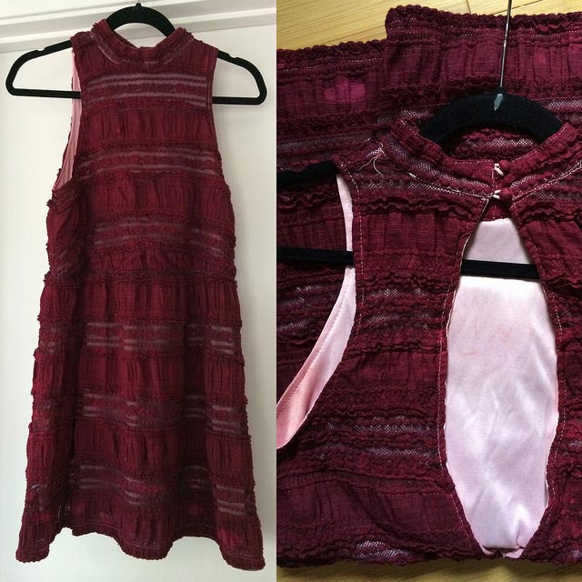 Burgundy sleeveless dress with textured horizontal panels on a hanger; close-up shows pale pink lining.