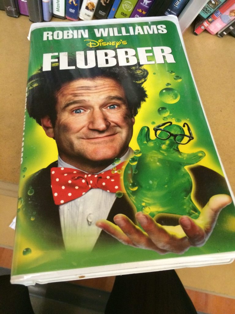 Poster for Disney's Flubber featuring Robin Williams and glowing green Flubber.