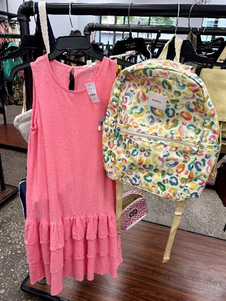 A picture of a pink dress and a colored backpack