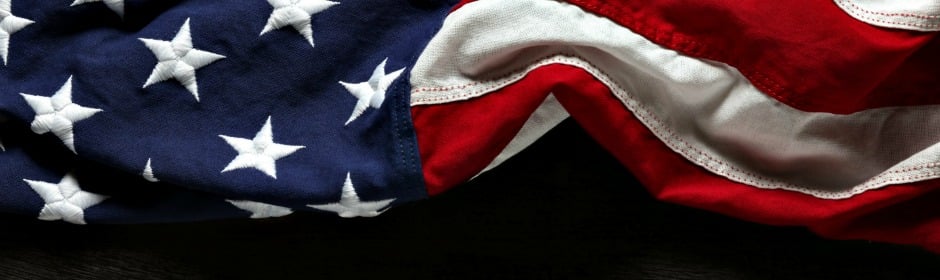 Close-up of the United States flag showing white stars on a blue field and red-and-white stripes.