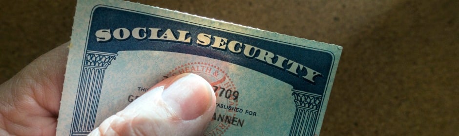 Close-up of a hand holding a Social Security card.
