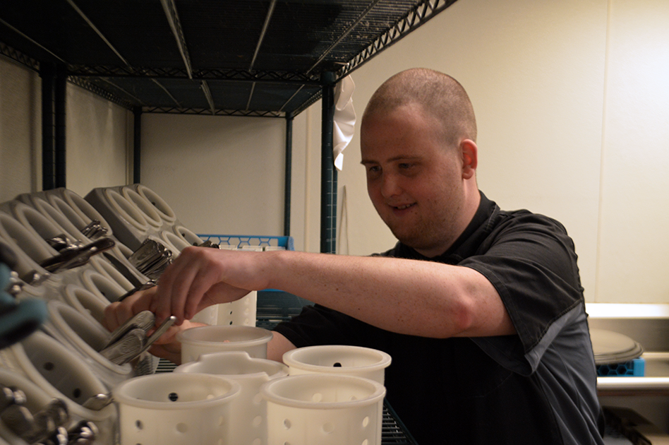 Thomas restocks silverware.