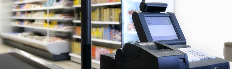 Point-of-sale cash register at a checkout counter in a grocery store