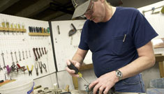 Bob May repairs a piece of equipment Bob May repairs a piece of equipment