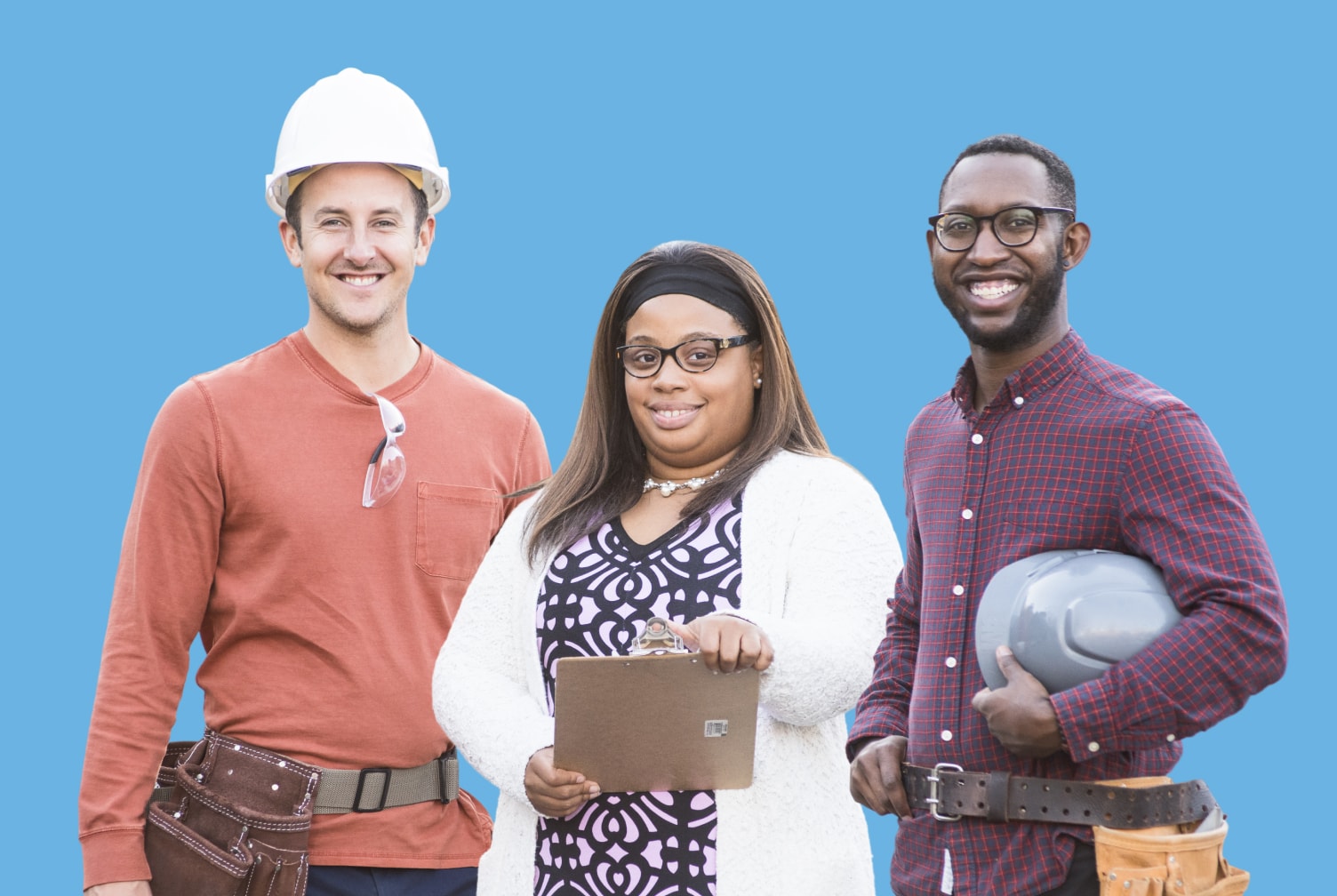 Three construction professionals posing together against a blue backdrop