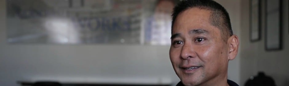 Smiling man in a modern office during an interview.