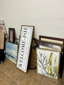 Picture frames laying on a wall on the floor