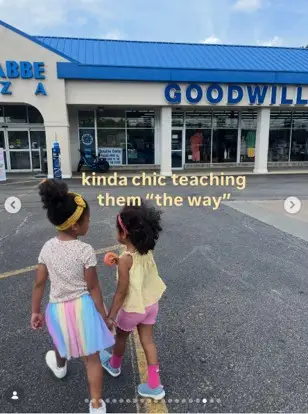 Two girls walking in front of a Goodwill store