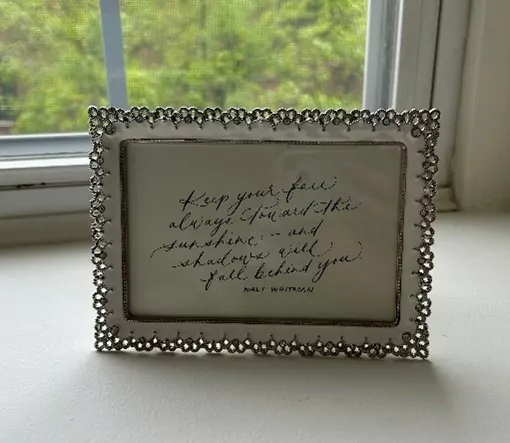 A picture frame with a handwritten note.