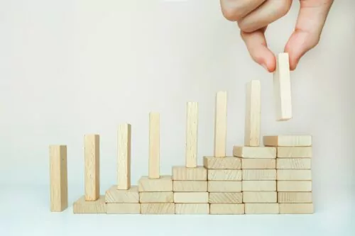 The domino effect is built by climbing the stairs on a wooden staircase lined with steps.
