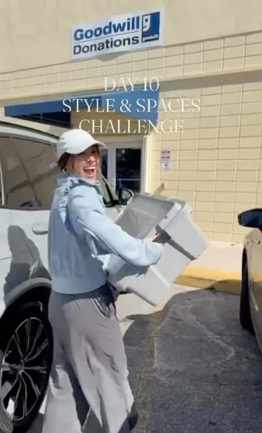 Womean wearing a jeans jacket and white hat holding donation boxes