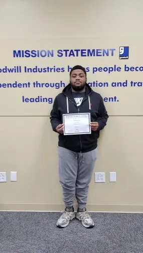 A picture of a man holding a certificate